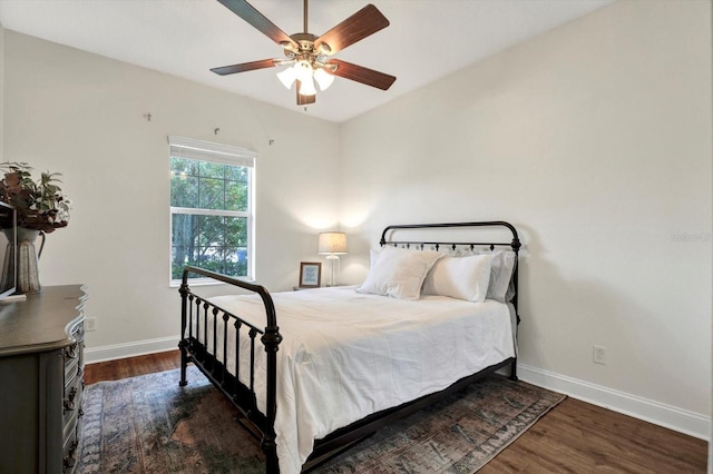 bedroom featuring baseboards, a ceiling fan, and wood finished floors