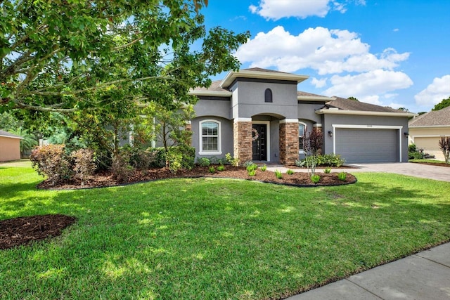 view of front of house featuring a garage, a front lawn, stone siding, stucco siding, and driveway