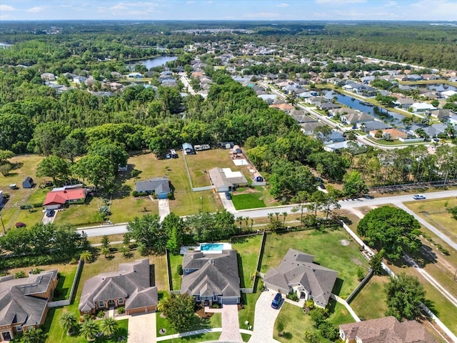 birds eye view of property with a residential view and a water view
