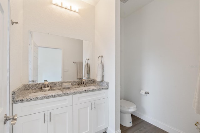 14404 SW 19th Pl, Ocala, FL 34481 - bathroom with double vanity, toilet, a sink, and wood finished floors