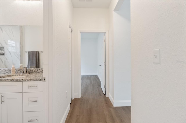 14404 SW 19th Pl, Ocala, FL 34481 - hall featuring a sink, baseboards, a textured wall, and wood finished floors