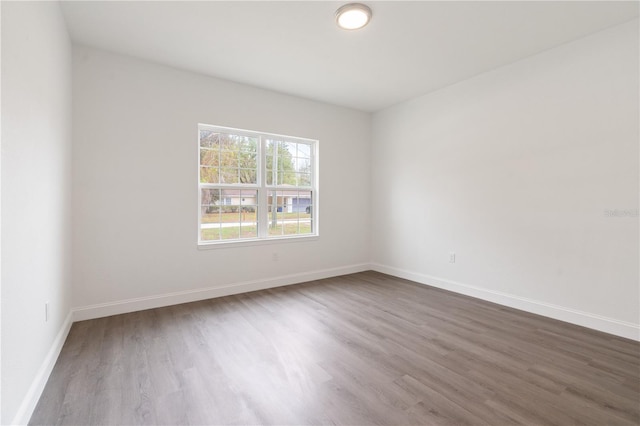 14404 SW 19th Pl, Ocala, FL 34481 - unfurnished room with baseboards and dark wood-type flooring
