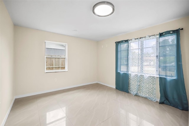 tiled spare room with baseboards