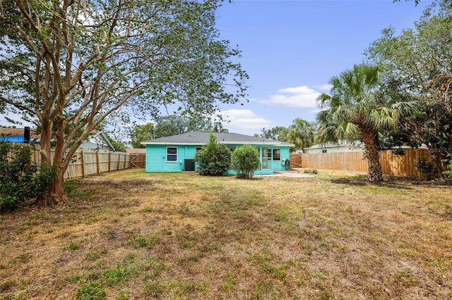 view of yard featuring a fenced backyard and central air condition unit