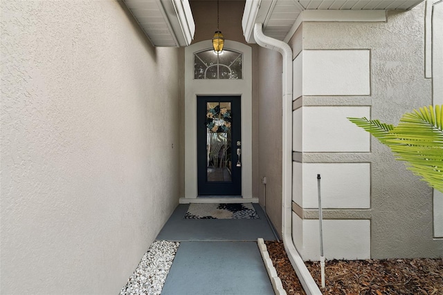 property entrance featuring stucco siding