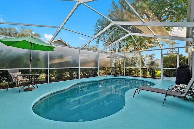 pool featuring a patio and glass enclosure