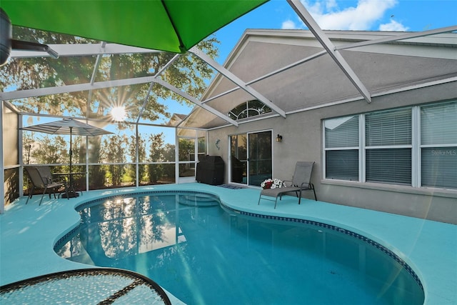 pool with a patio and glass enclosure
