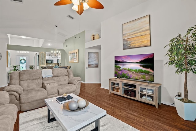 living room featuring visible vents, baseboards, ceiling fan with notable chandelier, and wood finished floors