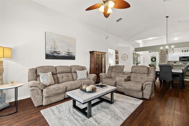 living room with baseboards, a ceiling fan, dark wood-style flooring, and high vaulted ceiling