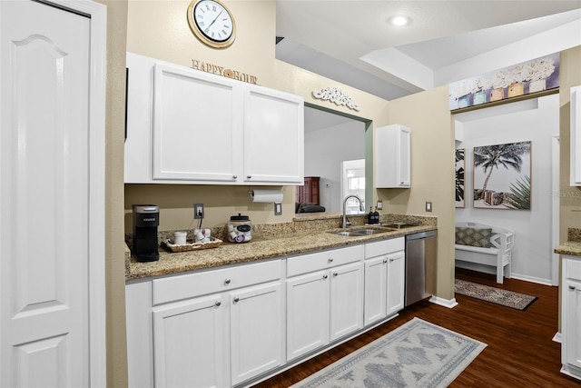kitchen with stainless steel dishwasher, a sink, white cabinetry, and dark wood-style floors