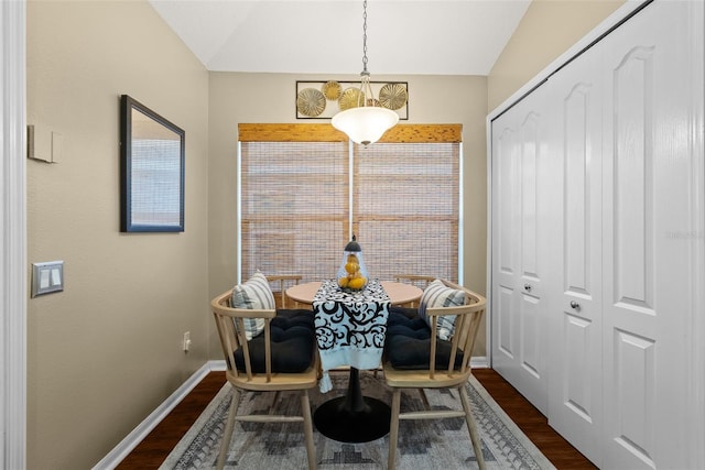dining room with baseboards, dark wood-style flooring, and lofted ceiling