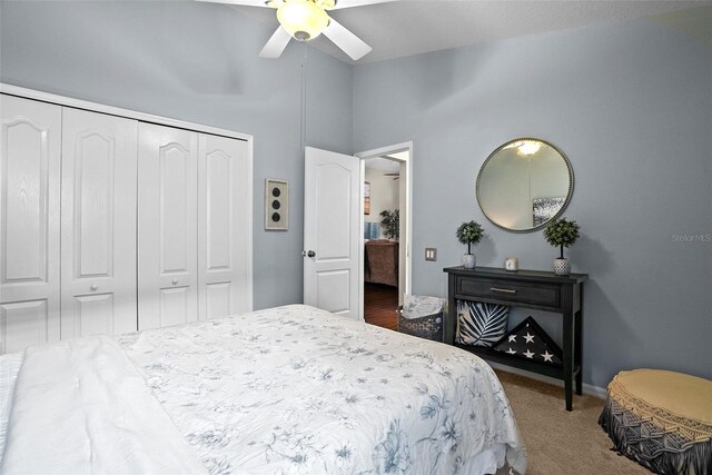 carpeted bedroom featuring high vaulted ceiling, baseboards, a ceiling fan, and a closet