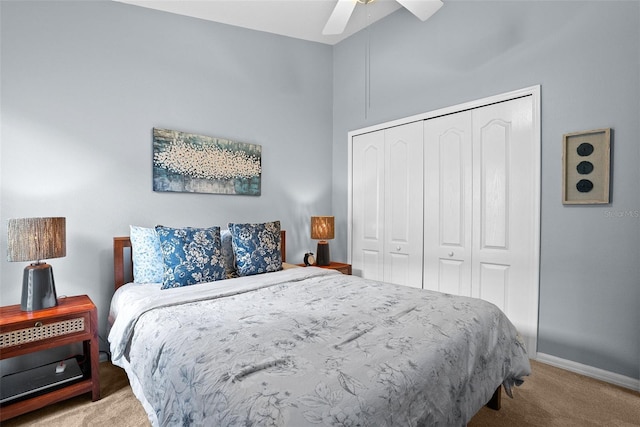 carpeted bedroom featuring a closet, baseboards, and ceiling fan