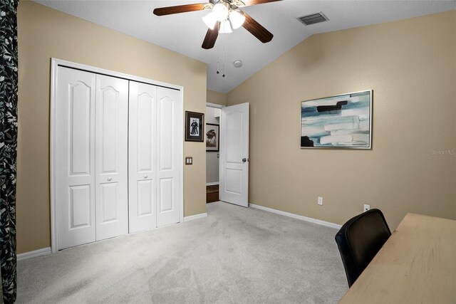 office area with visible vents, carpet floors, baseboards, a ceiling fan, and vaulted ceiling