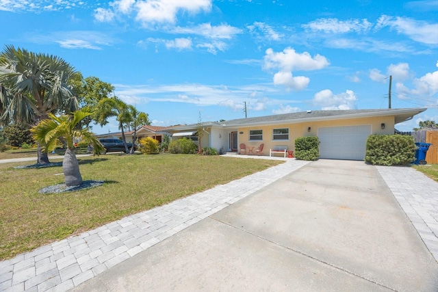 single story home featuring a garage, stucco siding, concrete driveway, and a front yard