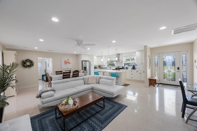 living area with baseboards, a ceiling fan, recessed lighting, and visible vents