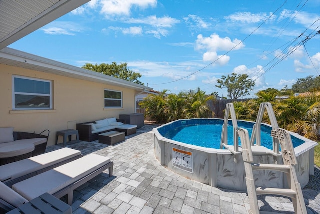 outdoor pool with a fenced backyard, an outdoor hangout area, and a patio area