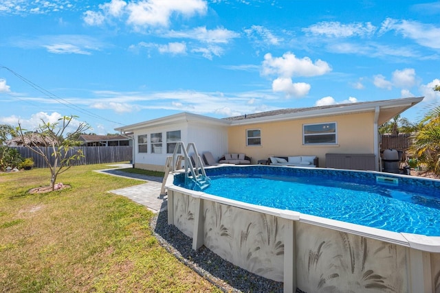 view of swimming pool featuring a lawn, a fenced backyard, an outdoor living space, and a fenced in pool