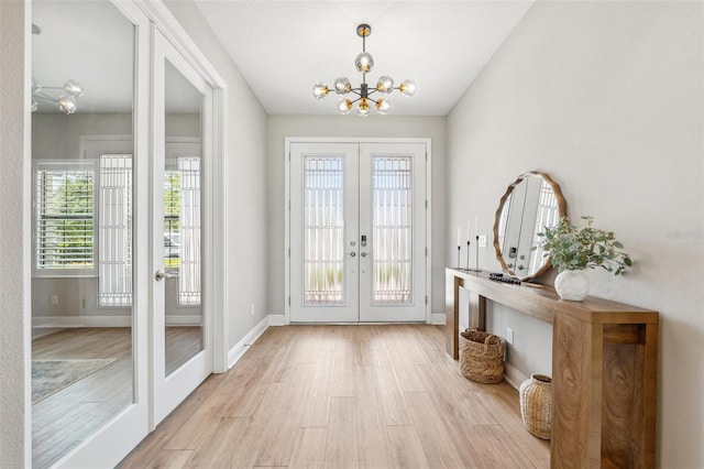 doorway to outside with a chandelier, french doors, and wood finished floors