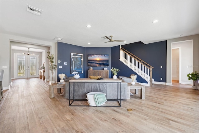 living room featuring visible vents, stairs, wood finished floors, baseboards, and recessed lighting