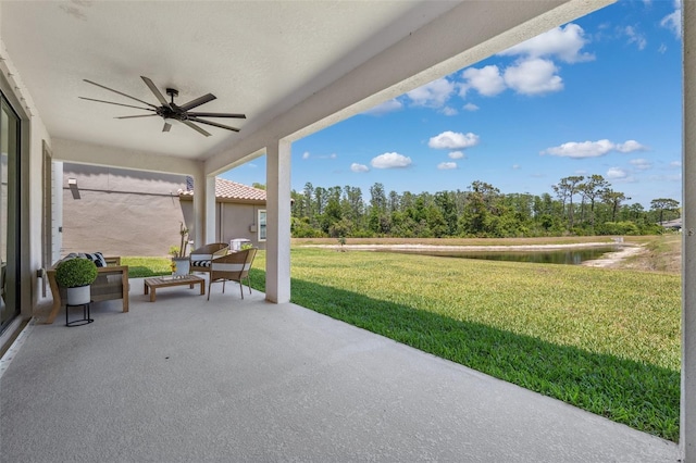 view of patio / terrace featuring a ceiling fan and a water view