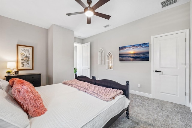 carpeted bedroom featuring visible vents, a ceiling fan, and baseboards