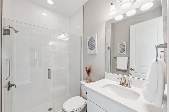 full bathroom featuring toilet, a shower stall, and vanity