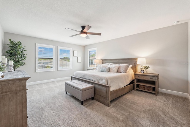 carpeted bedroom featuring baseboards and ceiling fan