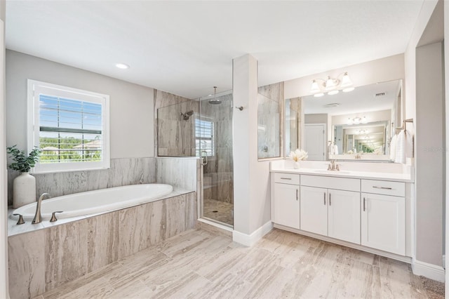 full bathroom with vanity, baseboards, a bath, a chandelier, and a stall shower