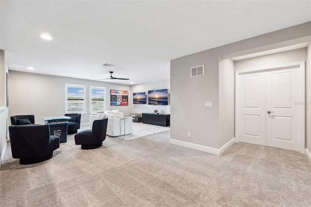 carpeted living room with baseboards, a ceiling fan, visible vents, and recessed lighting