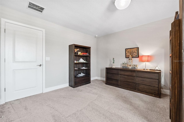 bedroom with light colored carpet, baseboards, and visible vents