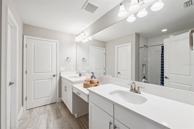 full bath featuring visible vents, baseboards, walk in shower, and vanity