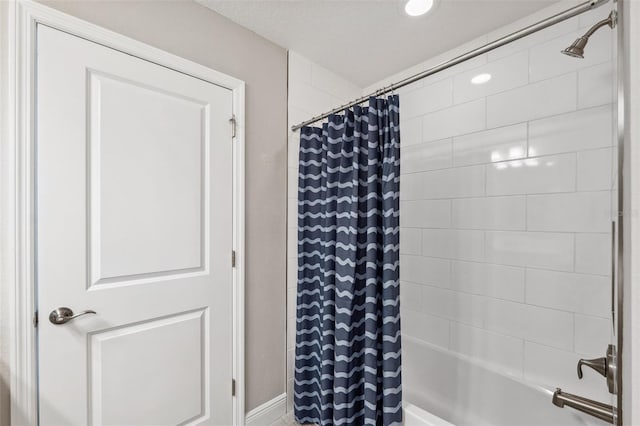 bathroom with recessed lighting and shower / bath combo