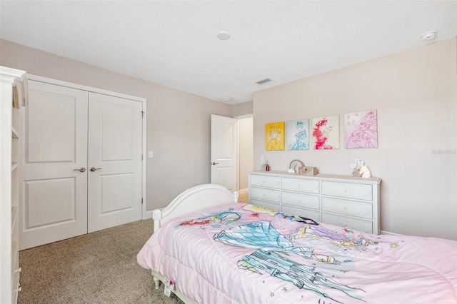 bedroom with visible vents, light carpet, and a closet