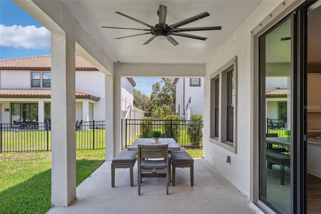 view of patio with ceiling fan, fence, and outdoor dining area