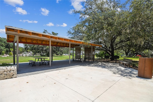 view of property's community with a lawn and a patio