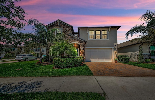 2653 Longleaf Pine Pt, New Port Richey, FL 34655 - traditional-style house featuring stucco siding, decorative driveway, an attached garage, and stone siding