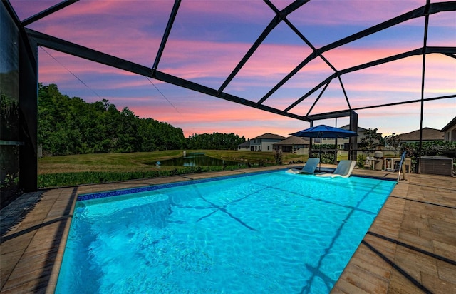 2653 Longleaf Pine Pt, New Port Richey, FL 34655 - swimming pool with glass enclosure, a water view, and a patio