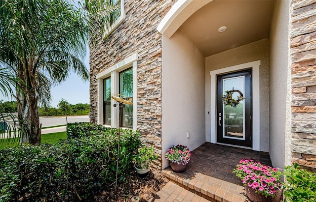 2653 Longleaf Pine Pt, New Port Richey, FL 34655 - view of exterior entry featuring stone siding and stucco siding