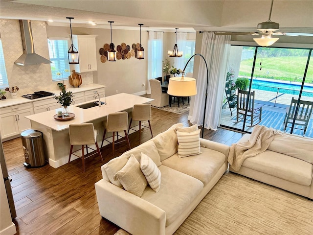 2653 Longleaf Pine Pt, New Port Richey, FL 34655 - living area featuring wood finished floors, a chandelier, ceiling fan, and crown molding