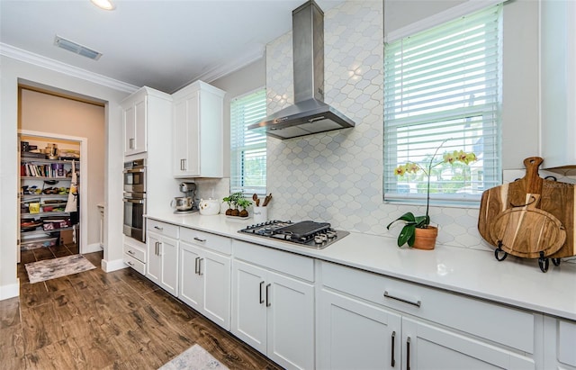 2653 Longleaf Pine Pt, New Port Richey, FL 34655 - kitchen featuring wall chimney range hood, appliances with stainless steel finishes, crown molding, light countertops, and white cabinets
