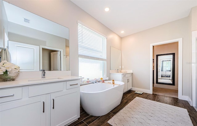 2653 Longleaf Pine Pt, New Port Richey, FL 34655 - full bath with two vanities, wood tiled floors, and a soaking tub