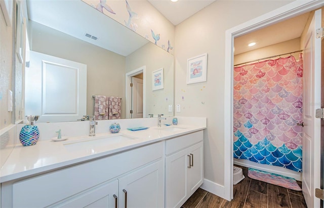 2653 Longleaf Pine Pt, New Port Richey, FL 34655 - full bathroom with double vanity, wood finished floors, and shower / bath combo