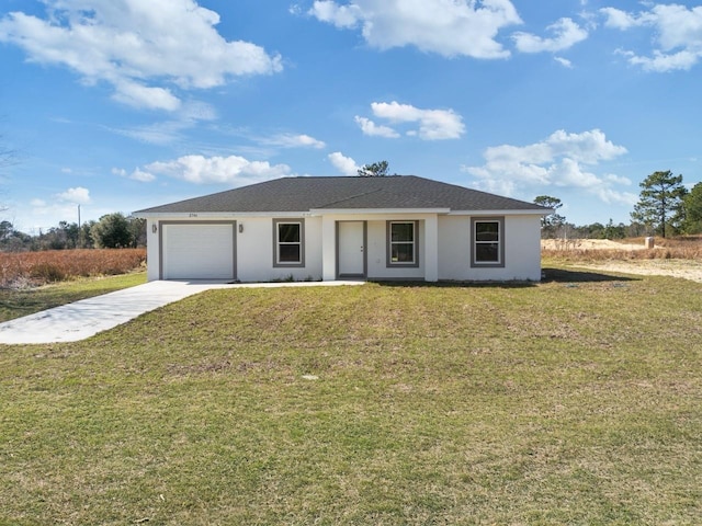 view of front facade with an attached garage, stucco siding, a front yard, and concrete driveway