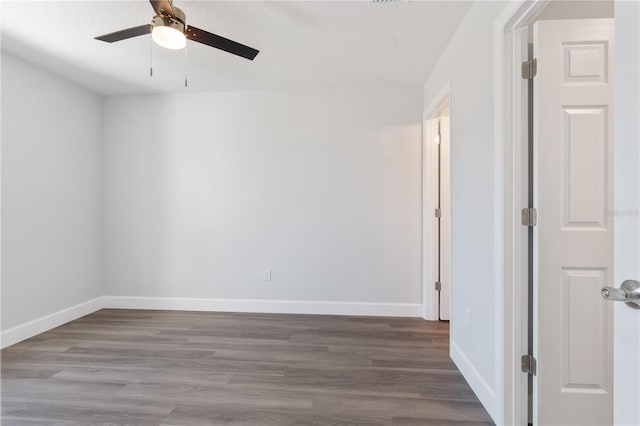 empty room with baseboards, a textured ceiling, ceiling fan, and wood finished floors