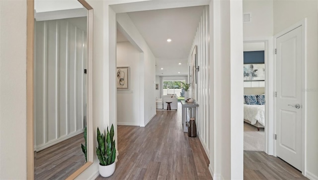 corridor with recessed lighting, baseboards, visible vents, and wood finished floors