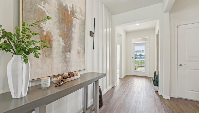 hall with baseboards and wood finished floors