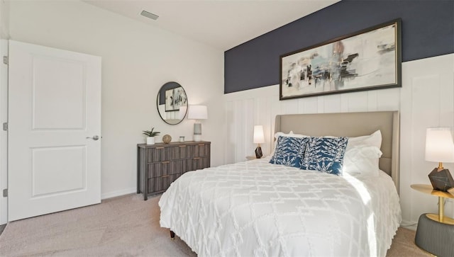 carpeted bedroom with visible vents and baseboards