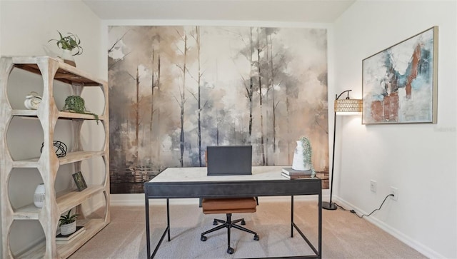 carpeted home office featuring baseboards and an accent wall