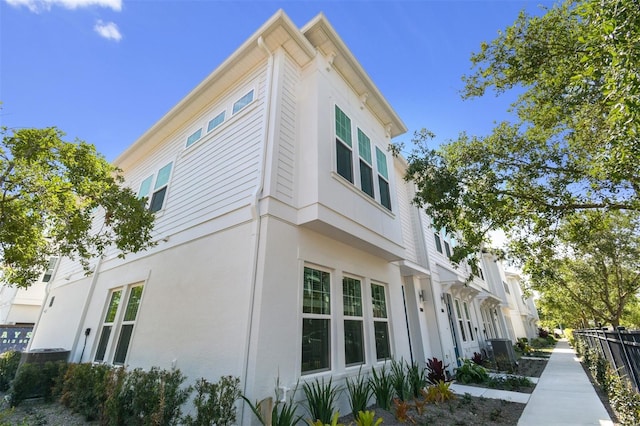 4717 W Mccoy St Unit 2, Tampa, FL 33616 - view of side of property with fence, central AC unit, and stucco siding